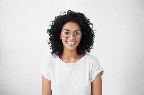 Attractive young woman with glasses smiling